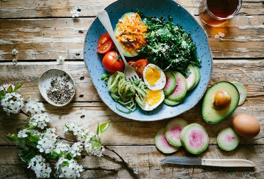 Colorful plate of vegetables, eggs, and avocado
