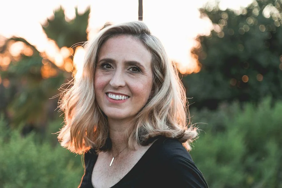 Smiling woman outdoors in warm evening light