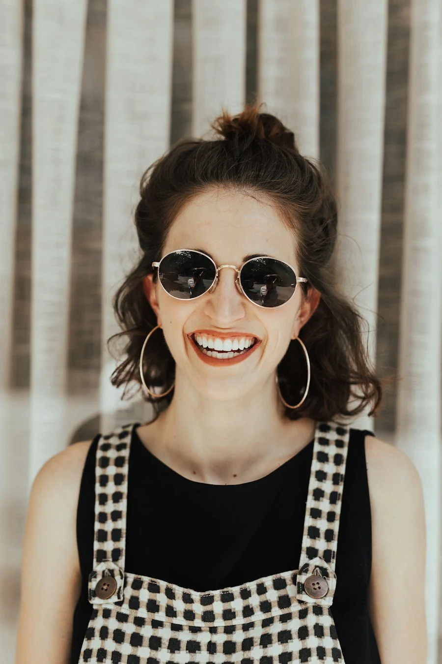 Smiling woman in sunglasses outdoors